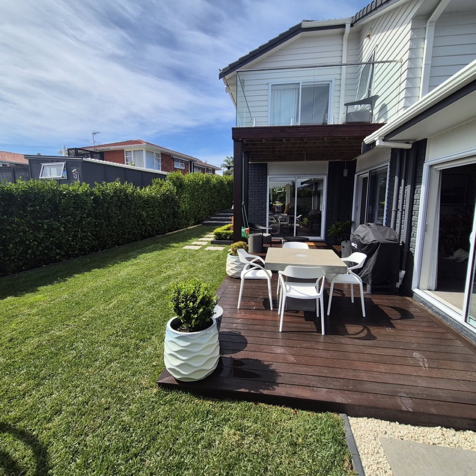 Kwila deck with fresh lawn and hedge